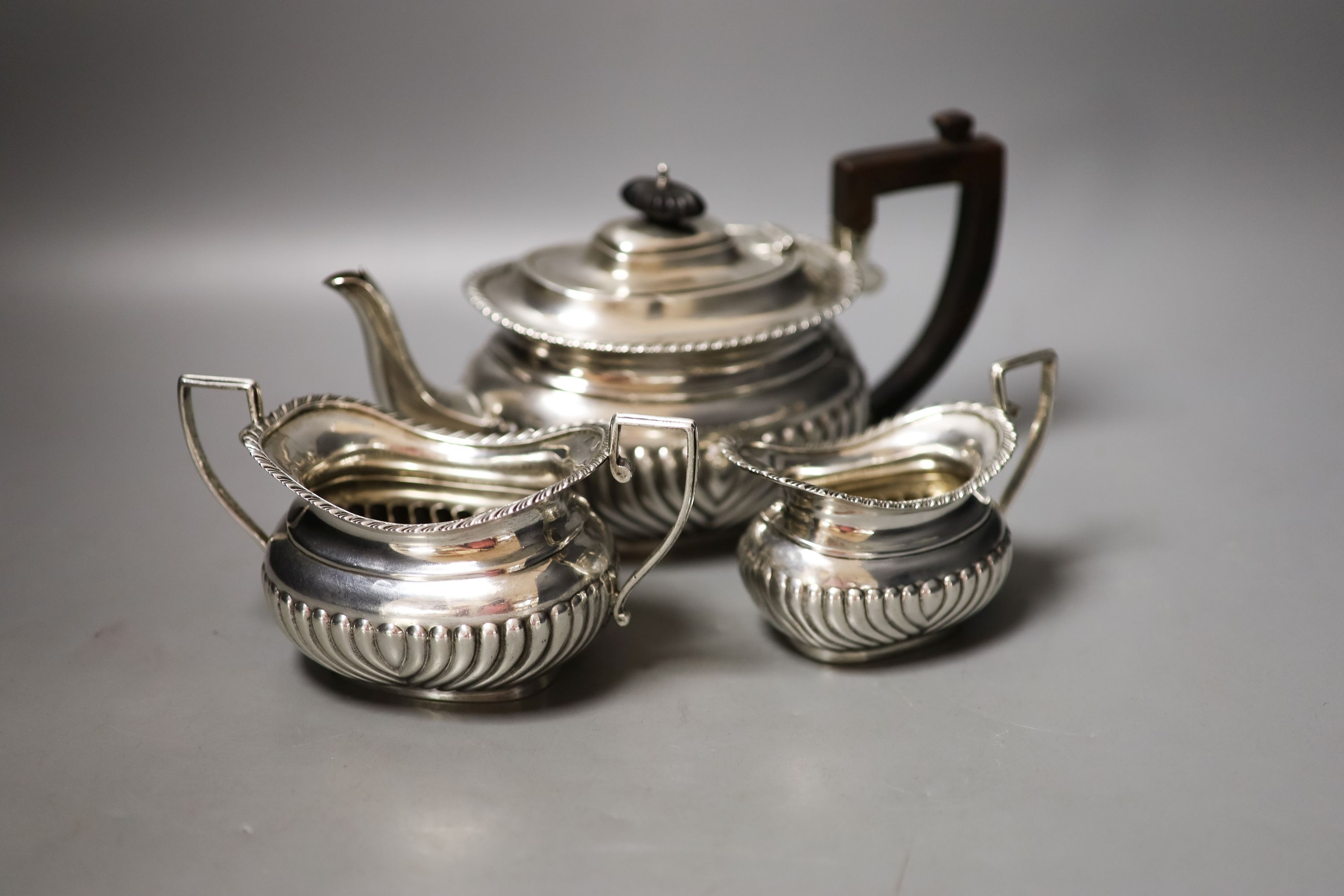 A late Victorian demi-fluted three piece tea set, Nathan & Hayes, Chester, 1896